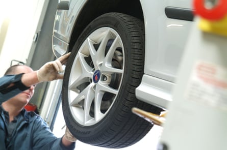 Mechanic inspecting tyres