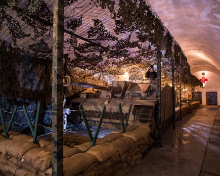 Tank, netting and sandbags in an underground bunker