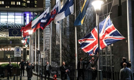 Staff members take down the union jack from outside the European parliament building in Brussels, 31 January 2020