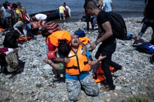 A Syrian refugee prays after arriving on Lesbos in September 2015.