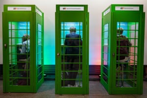 Delegates use of private booths based on telephone boxes at the conference venue