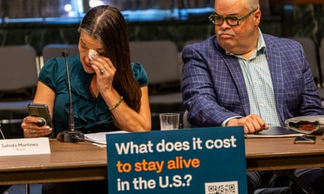 A woman cries as she speaks