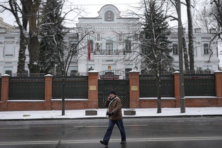 A pedestrian crosses the street in front of Chinese embassy in Kyiv, Ukraine.