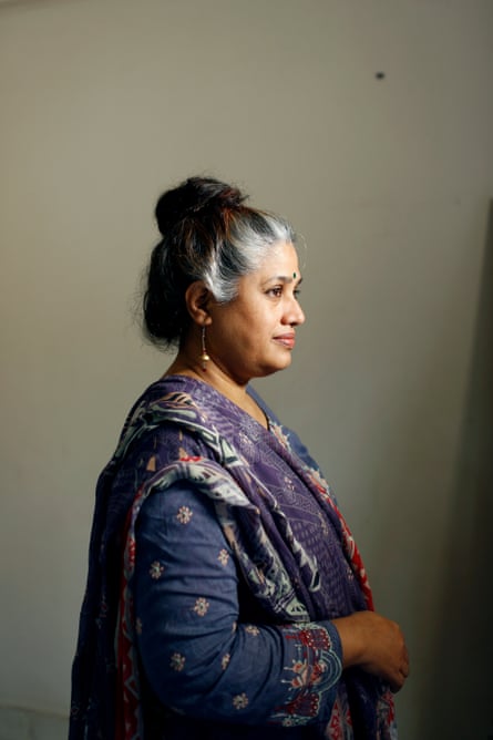 Portrait of a greying woman with a bun, wearing a shalwar kameez