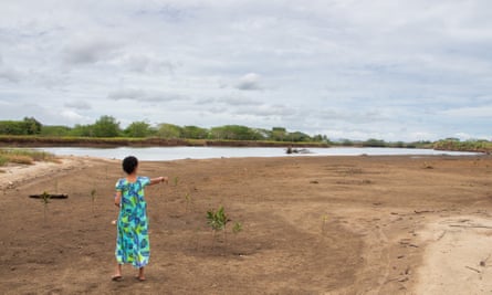 Meresiana Ubitu points at the river that widens every year on the banks of the Nadi river in Yavusania village.