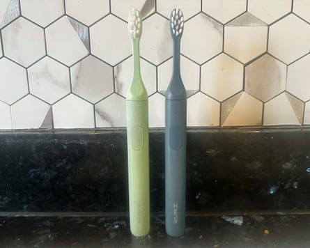 Suri 1 and Suri 2 toothbrushes on a bathroom worktop
