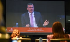 Alan Tudge is seen on a screen of the media room at the first hearing block of the royal commission into the robodebt scheme