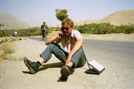 Luke on the road using a satellite telephone in Afghanistan in the early 2000s