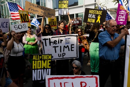 Lots of people holding signs saying Their Time is up and Bring them home now