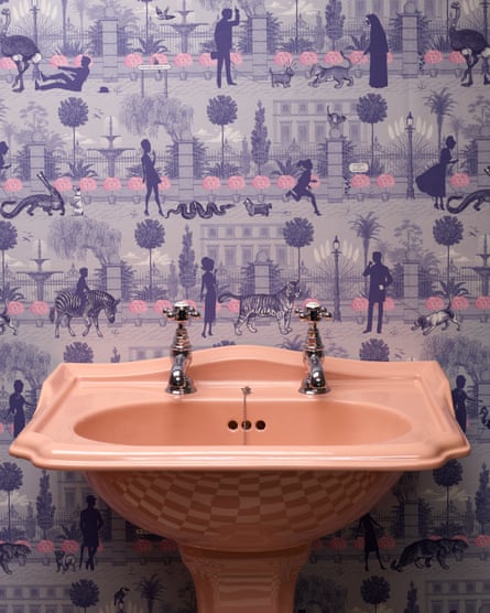 Making an impact: a peach-pink sink with a dramatic wallpaper.