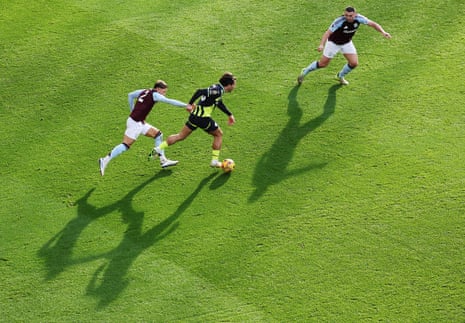 Jack Grealish of Manchester City runs with the ball while under pressure from Matty Cash and John McGinn during their match at Villa Park