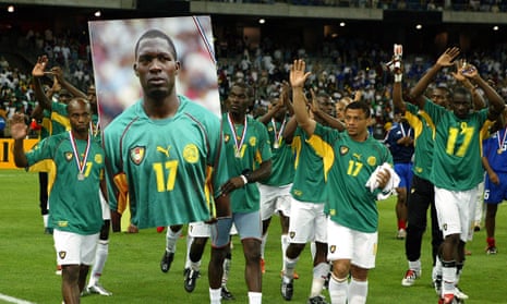 Cameroon team players carry a giant portrait of their late team mate Marc-Vivien Foe. Foe died after collapsing on the pitch during their match against Colombia. 