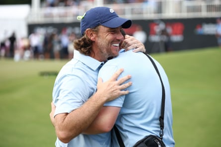 Tommy Fleetwood embraces his stepson, Oscar, on the 18th green after claiming victory at East Lake