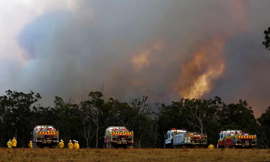 A bushfire approaches Old Bar, New South Wales, on Sunday.