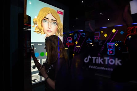A young woman makes a virtual image of herself at a TikTok stand during Vidcon in Mexico City.