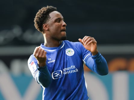 Wigan’s Christian Saydee applauds the fans