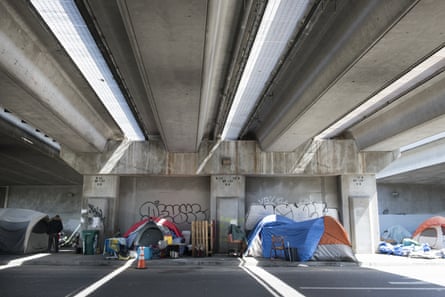 Tents line a sidewalk under an overpass at the 27th and Northgate homeless encampment in Oakland, California.