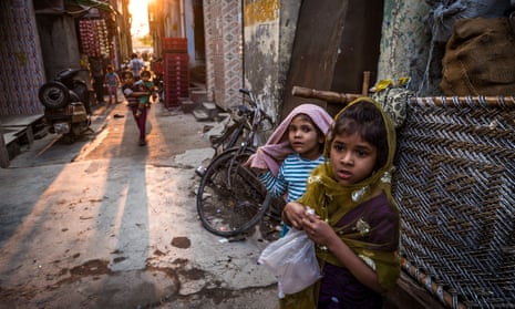 Young children play on the cramped streets of Delhi.