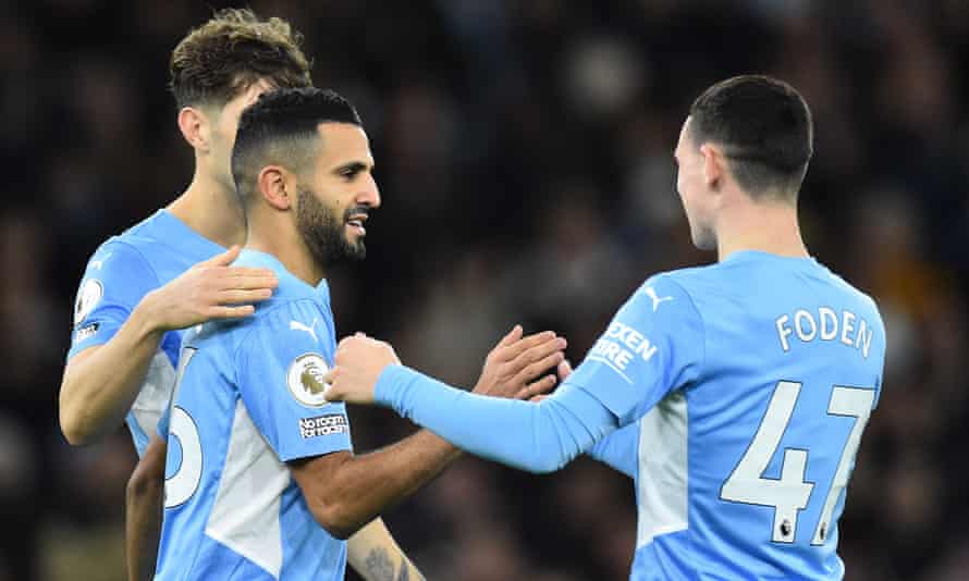 Riyad Mahrez (ccentre) celebrates with Phil Foden after scoring the fourth goal against Leeds.
