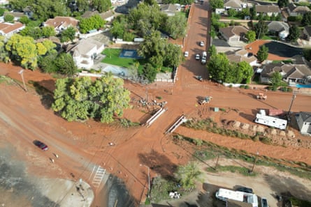 Aerial view of cars driving on muddy roads after flood