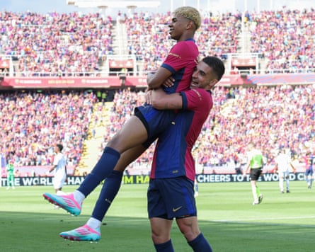 Barcelona’s Lamine Yamal celebrates scoring against Real Madrid with teammate Ferran Torres.