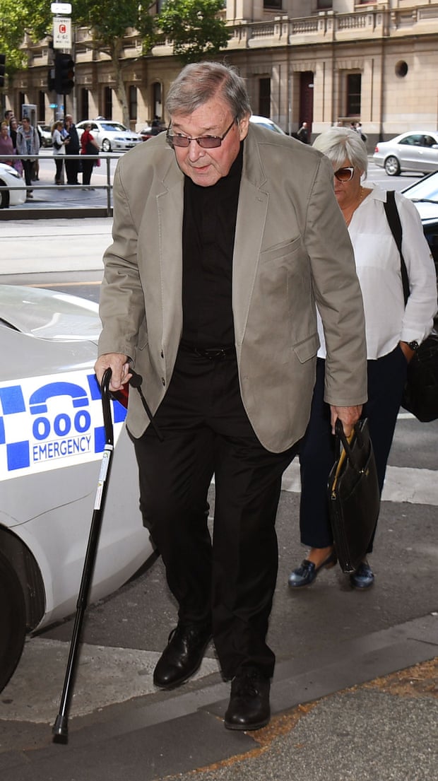 George Pell walking with a cane