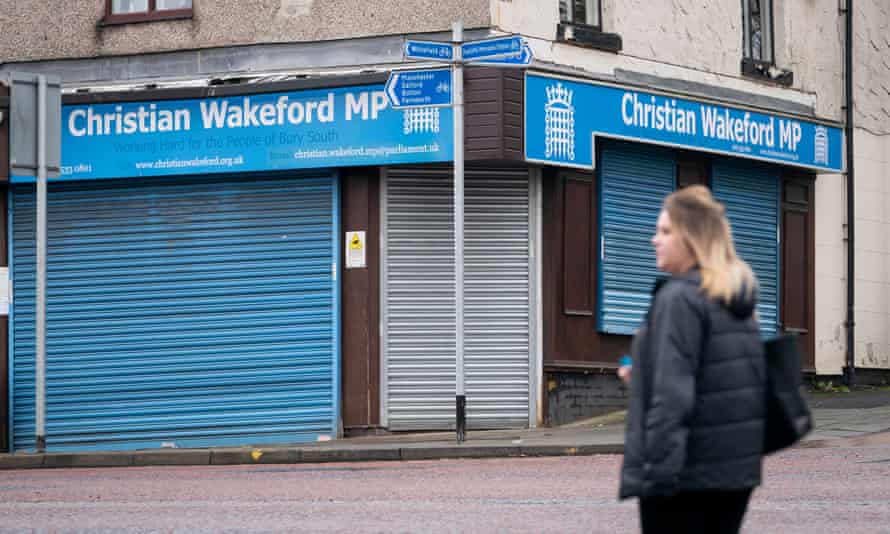 Woman walking past Christain Wakeford’s constituency office