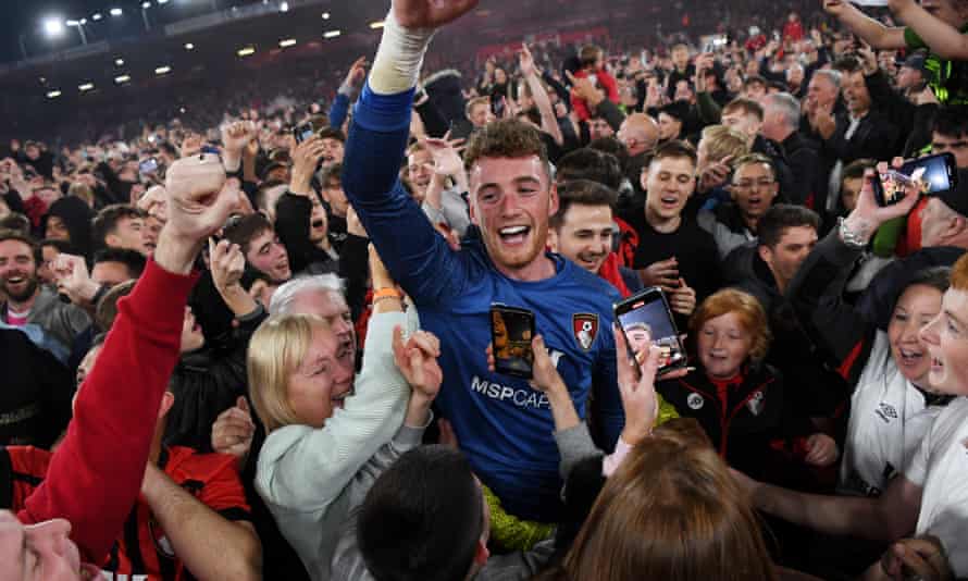 Mark Travers, the Bournemouth goalkeeper, joins fans in celebrations after his side sealed promotion.