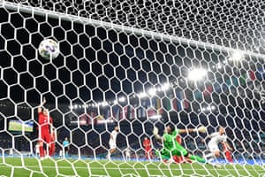 Italy’s forward Ciro Immobile (right) scores a goal.