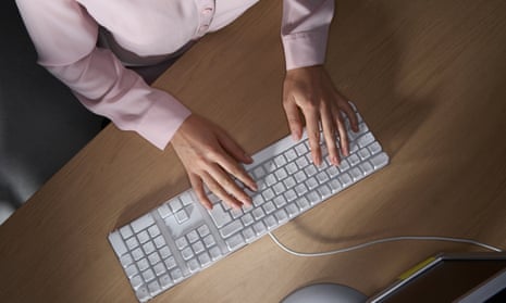 Woman’s hands typing on a computers keyboard