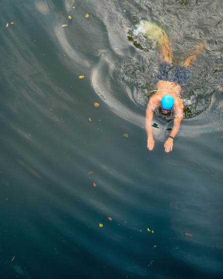 Man wild swimming in river.