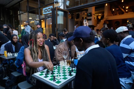 Two people playing chess on an individual table