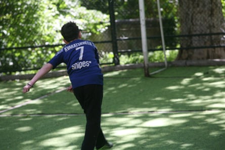 A local child wearing a Kvaratskhelia 7 Paris Saint-Germain shirt hits a left-footed shot while playing on Kvaratskhelia’s childhood football pitch in Tibilisi, the capital of Georgia
