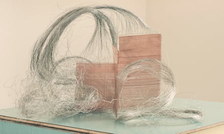 A woven basket-like structure with a mass of curling wire threads springing out of the top