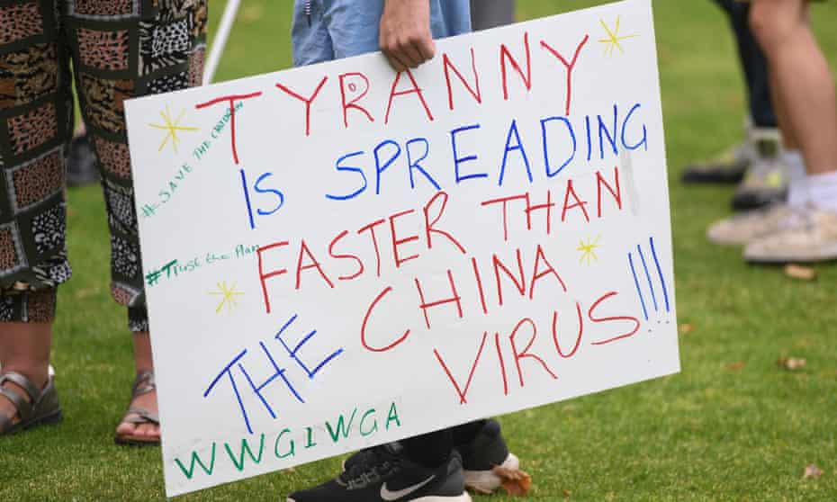 A sign featuring a QAnon conspiracy theory slogan is seen during an anti-vaccination rally in Melbourne, Saturday, February 20, 2021.