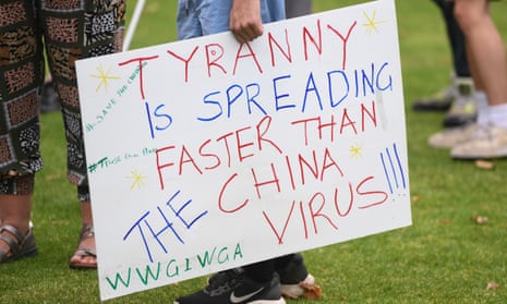 A sign featuring a QAnon conspiracy theory slogan is seen during an anti-vaccination rally in Melbourne, Saturday, February 20, 2021. 