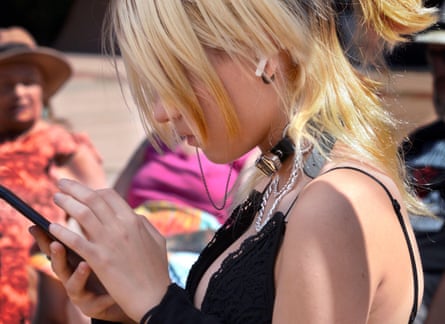 A teenage girl uses her smartphone