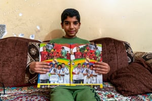 Khalid’s son, Hamid, 13, displays the cover of his maths book
