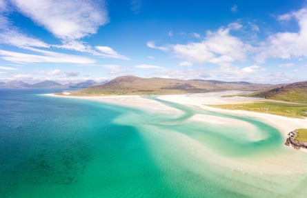 Aerial shot of beach in Scotland with white sands and turquoise waters