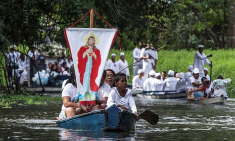 Roman Catholic pilgrims row boats on the river Caraparu in Brazil