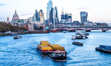 A tug pulling barges up Thames through London