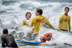 Petey, a West Highland terrier, barrels his way past lifeguards while taking a wave.