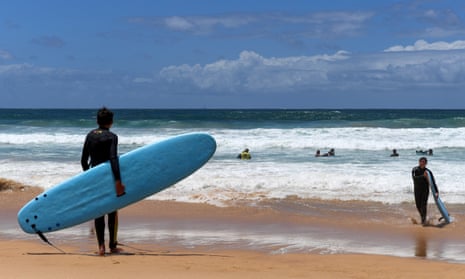 Surfers are seen in the water at Manly beach in Sydney