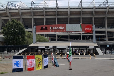 A vendor sells flags of various Mexican teams outside the Azteca stadium.
