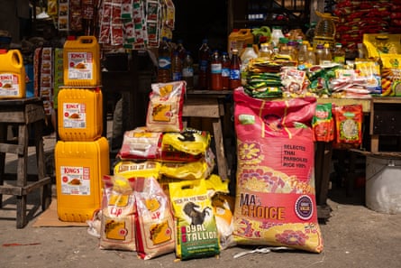 Large bags of rice, with oil and tomato puree displayed at a food stall