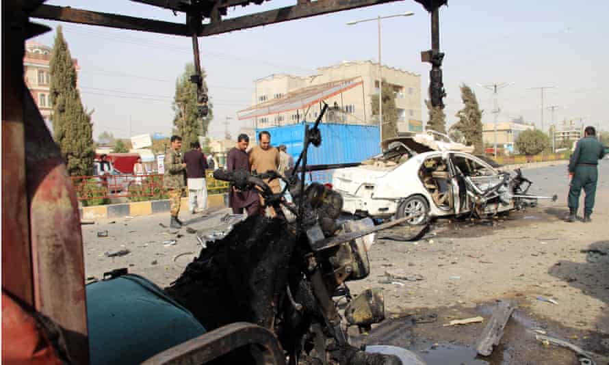 Afghan security officials inspect the scene of the explosion that killed Elyas Dayee in Lashkar Gah, the provincial capital of Helmand, on 12 November.