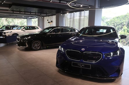 Four BMW cars shine under the showroom lights