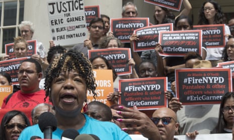Gwen Carr, whose son Eric Garner was killed by an NYPD officer, is surrounded by supporters as she speak during a news conference outside City Hall in New York on Tuesday.