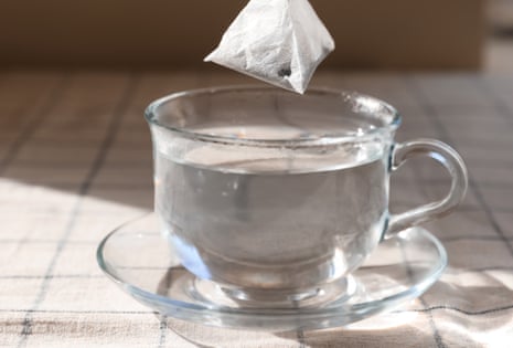 Tea bag being dipped into a cup