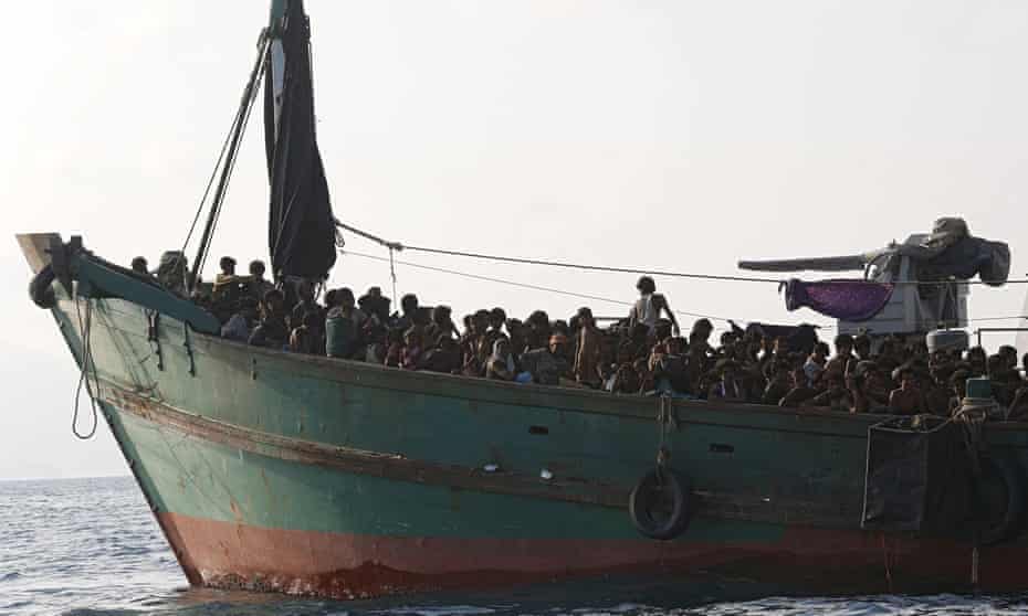 Migrants aboard a boat tethered to a Thai navy vessel, in waters near Koh Lipe island, on Saturday. 